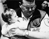 paramedic-holding-child